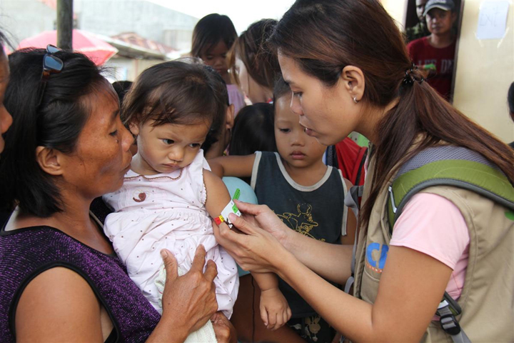 “An Action Against Hunger” nutrition expert measures children for malnutrition in disaster-struck Panay Island, Philippines on Thursday November 28, 2013. (Photo credit: CNW Group/Action Against Hunger)