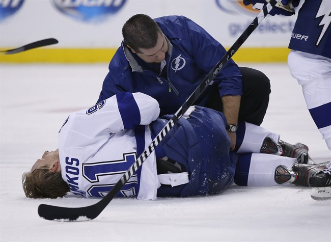 Tampa Bay Lightning center Steven Stamkos is attended to on the ice after banging into the goalpost during the second period of an NHL hockey game against the Boston Bruins in Boston Monday, Nov. 11, 2013. 