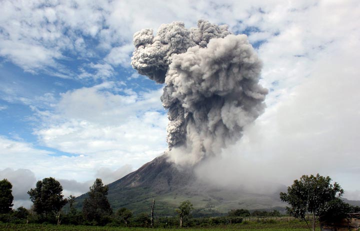 Mount Sinabung spews volcanic material as seen from Karo, North Sumatra, Indonesia, Sunday, Nov. 24, 2013.