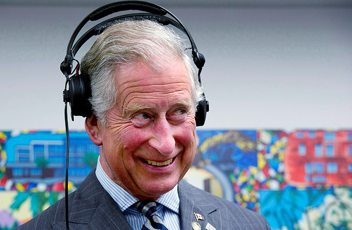 Prince Charles wears headphones as learns how to scratch and fade with a turntable while he tours an employment skills workshop in Toronto, on Tuesday, May 22, 2012. The royal couple is on a four-day visit to Canada to mark the Queen’s Diamond Jubilee. (Photo credit: AP Photo)