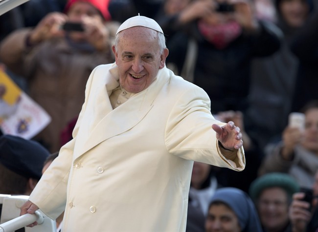 Pope Francis waves as he arrives for his weekly general audience in St. Peter's Square at the Vatican, Wednesday, Dec. 11, 2013.