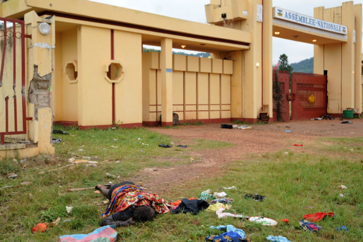 The body of a man killed during recent clashes in front of the National Assembly building in Bangui remains outside the assembly building, on December 6, 2013. French troops have killed several armed fighters in the Central African Republic as Paris on December 6 rolled out a UN-backed operation to restore security after a bloodbath that left scores of bodies strewn across the capital. (Photo by Sia Kambou/AFP/Getty Images)