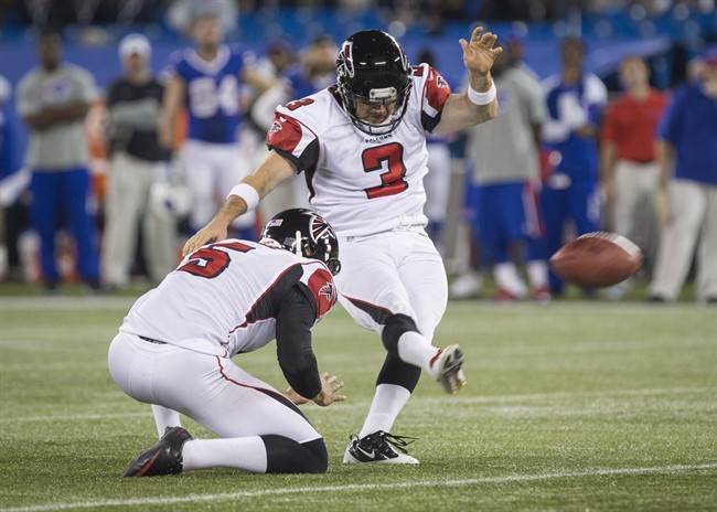 Atlanta Falcons kicker Matt Bryant kicks the game winning field goal with Matt Bosher, left, to defeat the Buffalo Bills in overtime of NFL action in Toronto, Sunday December 1, 2013. THE CANADIAN PRESS/Mark Blinch