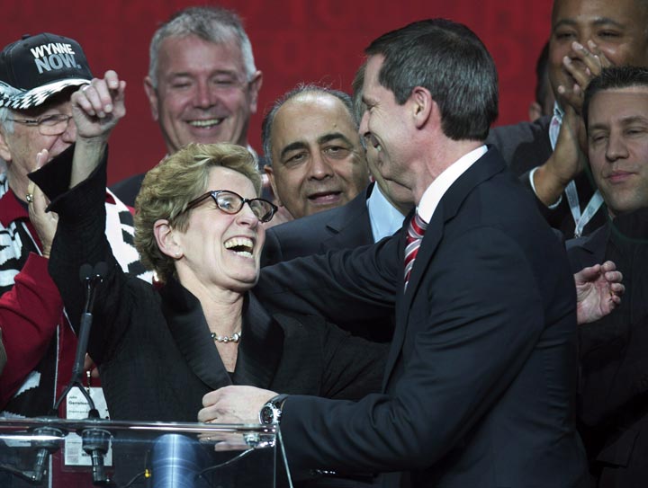Ontario Premier Kathleen Wynne is congratulated by outgoing Premier Dalton McGuinty after winning the leadership race at the Ontario Liberal Party leadership convention in Toronto. (The Canadian Press /Frank Gunn)