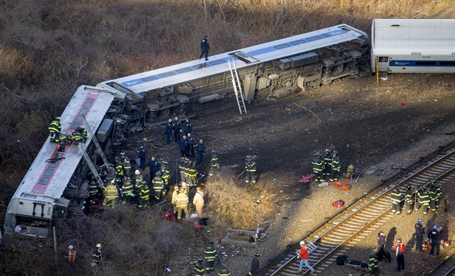 First responders gather at the derailment of a Metro-North passenger train in the Bronx borough of New York Sunday, Dec. 1, 2013.
