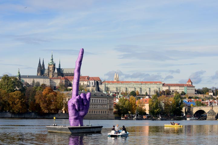 People sailing on boats on Vltava River look at a giant purple finger sculpture by Czech artist David Cerny in Prague. (Michal Cizek/AFP/Getty Images)