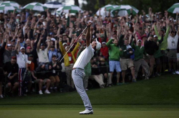 Adam Scott celebrates after making a birdie putt on the second playoff hole to win the Masters golf tournament on Sunday, April 14, 2013, in Augusta, Ga. (AP Photo/David J. Phillip)
