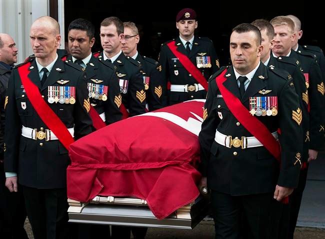 Members of The Royal Canadian Regiment carry the casket at the funeral for Warrant Office Michael Robert McNeil at the Truro Armouries in Truro, N.S. on Thursday, Dec. 5, 2013. McNeil completed several tours of duty including Afghanistan, Bosnia and Croatia. McNeil took his own life late last month at CFB Petawawa. THE CANADIAN PRESS/Andrew Vaughan.