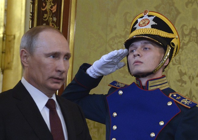 Russian President Vladimir Putin, left, walks to meet his Ukrainian counterpart Viktor Yanukovych during their meeting in Moscow on Tuesday, Dec. 17, 2013. 