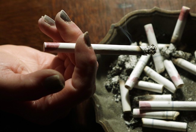 A woman smokes a cigarette in Hayneville, Ala., March 2, 2013.