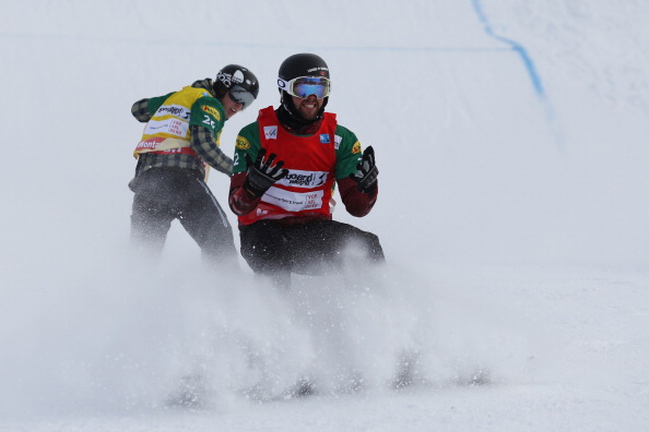 Canada's Kevin Hill reacts at the end of the second semi final in front of Finland's Amnton Lindfors at the men's snowboard cross event as part of the FIS Snowboard world cup season opening, in Schruns Montafon on December 7, 2013.