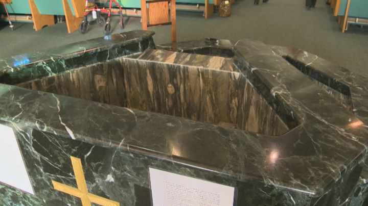 The holy water font at St. Thomas More Catholic Church in Edmonton has been emptied.