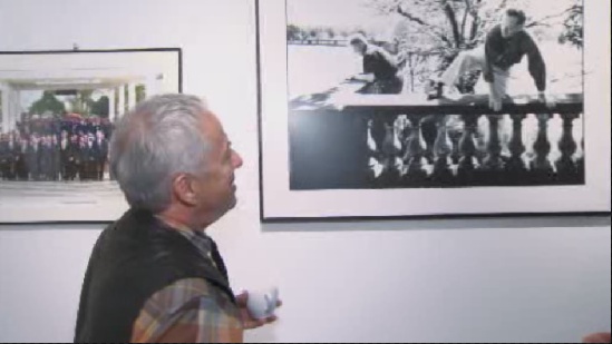 Jean-Marc Carisse at his gallery cafe in Ottawa, looking at one of his famous photographs.