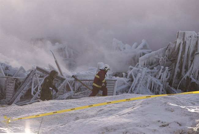 Firefighters work at the scene of a fatal fire at a seniors residence in L'Isle-Verte, Que., Thursday, January 23, 2014.