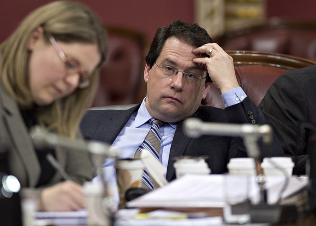 Quebec Minister Bernard Drainville listens to a participant during a legislature committee studying the proposed Charter of Values on secularism, Tuesday, January 14, 2014 in Quebec City.