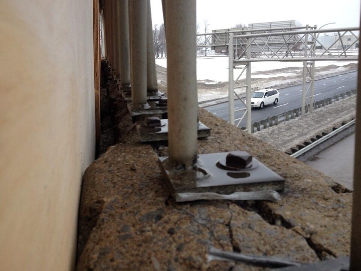 A gap can be seen between the concrete overpass and a wooden plank installed by Transports Quebec on the Henri-Bourassa overpass in Montreal on January 14, 2014.
