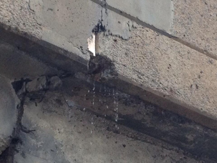 Cracks and holes allow water to pour off of the Henri-Bourassa overpass not far from falling concrete.