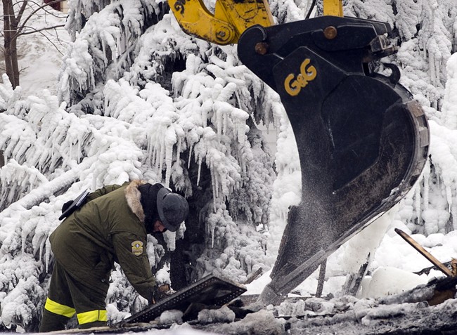 Firefighters work at the scene of a fatal fire at a seniors residence in L'Isle-Verte, Que., Thursday, January 23, 2014.