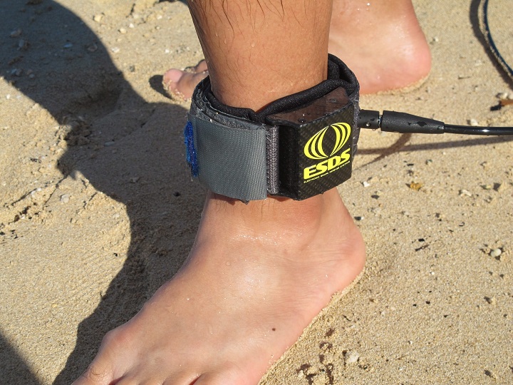 A surfer models a shark deterrent device, the Electronic Shark Defense System, in Honolulu on Dec. 17, 2013. 