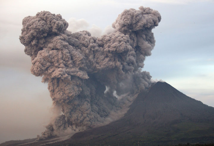 Mount Sinabung spews volcanic materials as seen from Gundaling, North Sumatra, Indonesia, Wednesday, Jan. 8, 2014.
