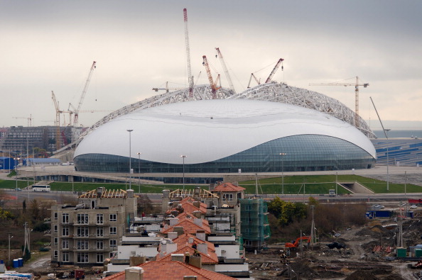 The Bolshoy Ice Dome is seen beyond the partially-completed buildings of the athletes village in the Sochi district of Adler, on February 18, 2013.