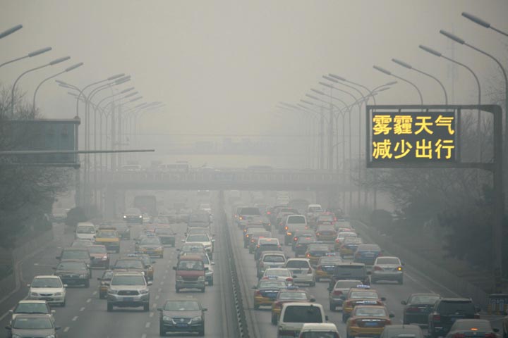 Vehicles clog a main highway during a sixth straight day of severe pollution in Beijing Tuesday, Feb. 25, 2014. (AP Photo/Ng Han Guan)