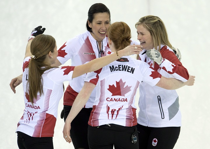 Canada skip Jennifer Jones (right) Dawn McEwen, Kaitlyn Lawes (left) and Jill Officer (back) celebrate after winning the gold medal during Olympic final curling action against Sweden at the Sochi Winter Olympics Thursday in Sochi, Russia.