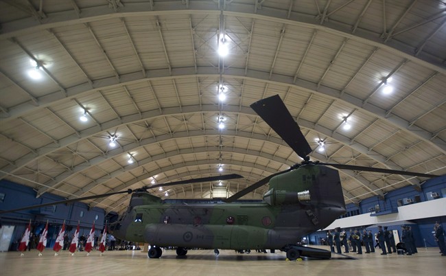 A new Chinook CH-147F helicopter sits in a hangar before an event June 27, 2013 in Ottawa.
