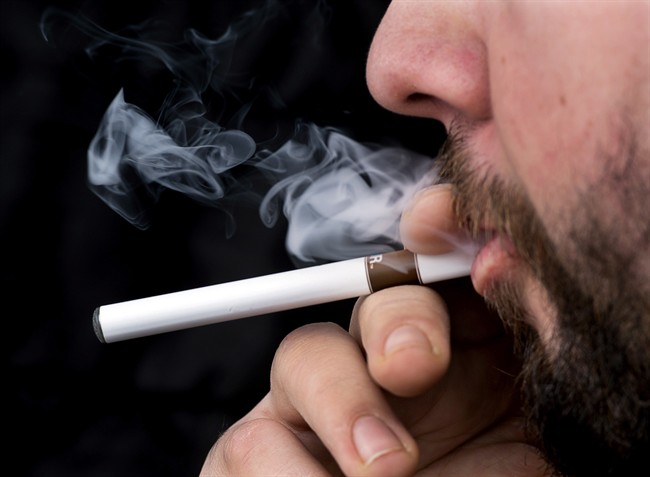A smoker puffs on an electronic cigarette in Halifax. As the debate continues over who's puffing on e-cigarettes and why, another controversy is heating up: how should they be regulated?.