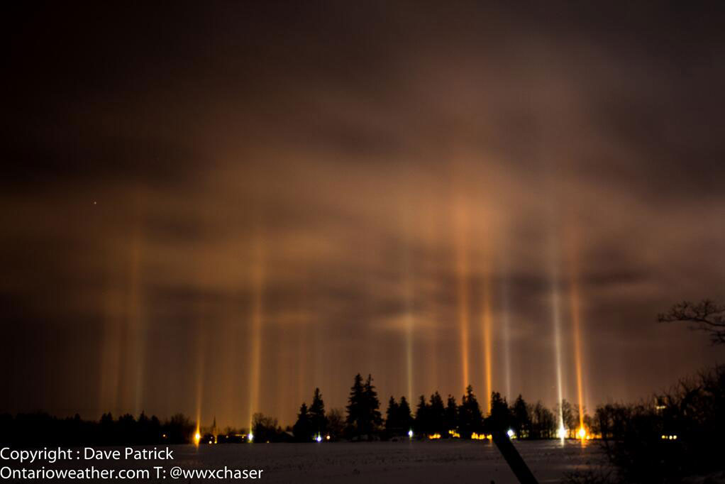 Lights from the ground that are reflected into the night sky are sent back down to their source via ice crystals, creating beautiful light pillars.