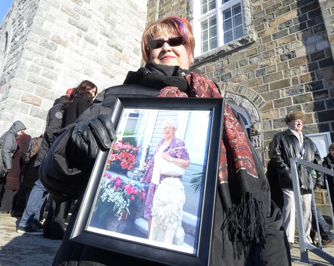 Marie Caron holds a photo of her aunt Jacqueline Caron, 89, one of the victims of the seniors' residence fire in L'Isle-Verte, Que.