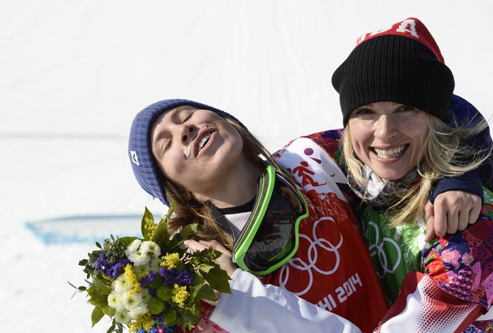 Gold Medallist, Czech Republic’s Eva Samkova (L) celebrates with Silver Medallist, Canada’s Dominique Maltais during the Women’s Snowboard Cross Flower Ceremony at the Rosa Khutor Extreme Park during the Sochi Winter Olympics on February 16, 2014. (Franck Fife/AFP/Getty Images)