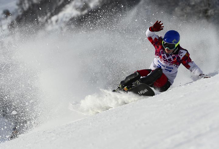 Canada’s Michael Lambert crashes in the Men’s Snowboard Parallel Giant Slalom qualification run at the Rosa Khutor Extreme Park during the Sochi Winter Olympics on February 19, 2014. (Javier Soriano/AFP/Getty Images)