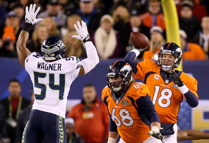 Quarterback Peyton Manning of the Denver Broncos throws an interception caught by strong safety Kam Chancellor and intended for tight end Julius Thomas of the Denver Broncos in the first quarter during Super Bowl XLVIII at MetLife Stadium on February 2, 2014 in East Rutherford, New Jersey. (Jeff Gross/Getty Images)