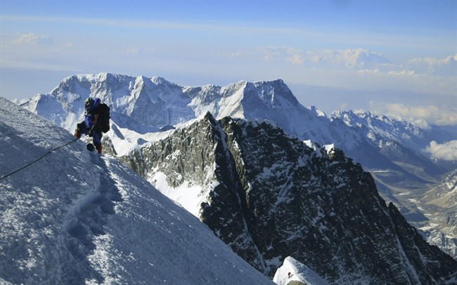 In this May 18, 2013 photo released by Alpenglow Expeditions, a climber pauses on the way to the summit of Mount Everest, in the Khumbu region of the Nepal Himalayas.