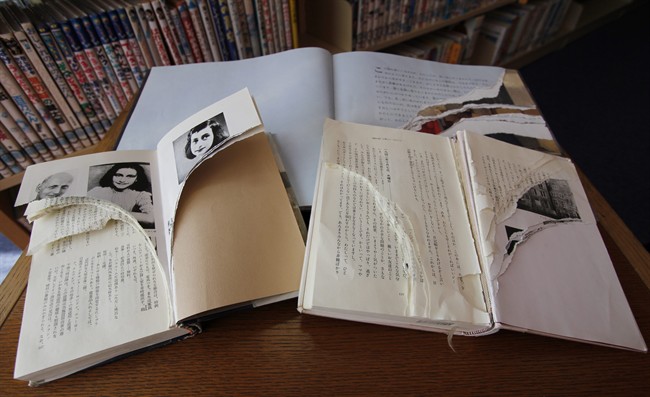 Ripped copies of Anne Frank's "Diary of a Young Girl" and related books are shown at Shinjuku City Library in Tokyo Friday, Feb. 21, 2014. Tokyo Libraries said on Friday that hundreds of copies of Anne Frank's diary and related books have been found vandalised across the city's libraries in the last month, sparking fears of an anti-Semitic motive. A total of 265 books in 31 libraries had been found damaged after the first damaged book was found in January, prompting a wider search. (AP Photo/Koji Ueda).