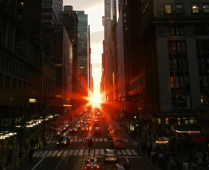 The sun is seen as it sets between Manhattan buildings on 42nd Street during a phenomenon known as "Manhattanhenge," , July 13, 2011. 