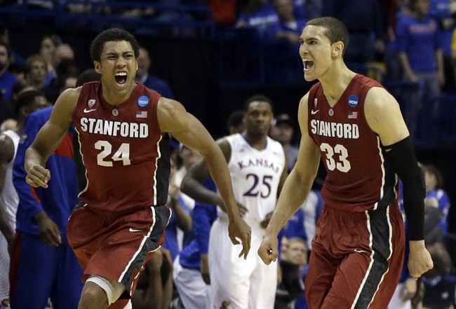 Stanford’s Josh Huestis, left, and Dwight Powell, right, celebrate as Kansas’ Tarik Black (25) watches in the background after in a third-round game of the NCAA college basketball tournament Sunday, March 23, 2014, in St. Louis.