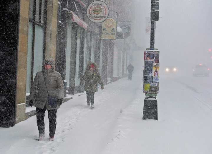 .Pedestrians battle high winds and blowing snow as they walk in downtown Halifax on Wednesday, March 26, 2014