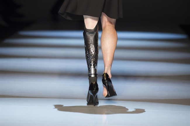 A model wears a prosthesis as she shows a creation from VAWK while walking the runway during Toronto Fashion Week in Toronto on Wednesday March 17, 2014.