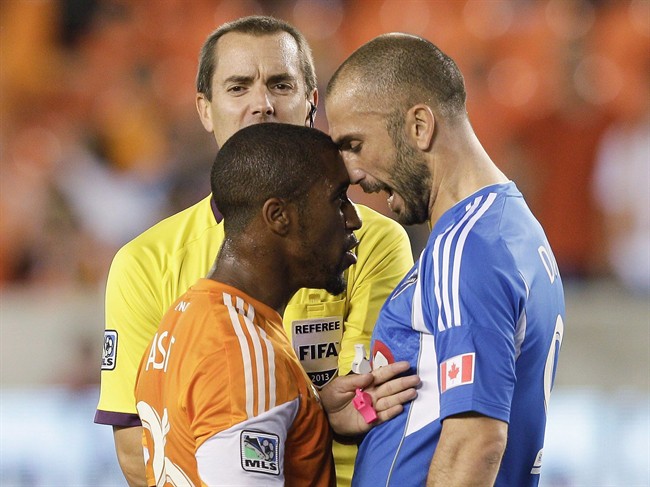 Houston Dynamo midfielder Corey Ashe has words with Montreal Impact forward Marco Di Vaio.
