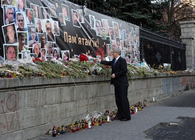 Prime Minister Stephen Harper lays a bouquet of flowers in Kiev, Ukraine, on Saturday, March 22, 2014. THE CANADIAN PRESS/Sean Kilpatrick