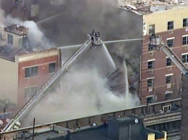 In this image taken from video from WABC, firefighters battle a blaze at the site of a possible explosion and building collapse in the East Harlem neighborhood of New York, Wednesday, March 12, 2014.