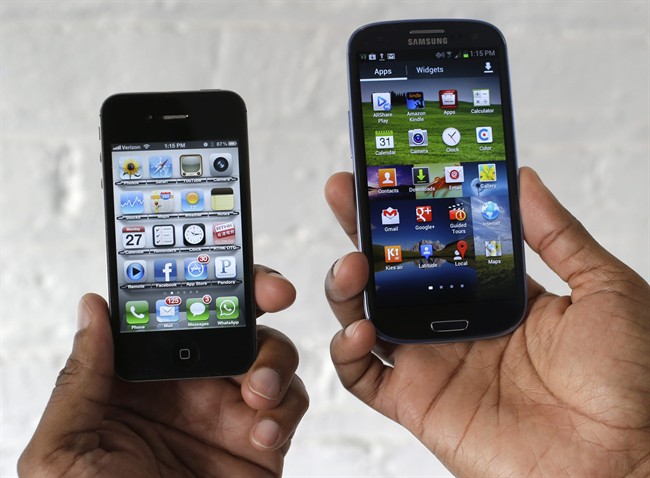 In this Aug. 27, 2012 photo, the Apple iPhone 4s, left, is displayed next to the Samsung Galaxy S III at a store in San Francisco. 