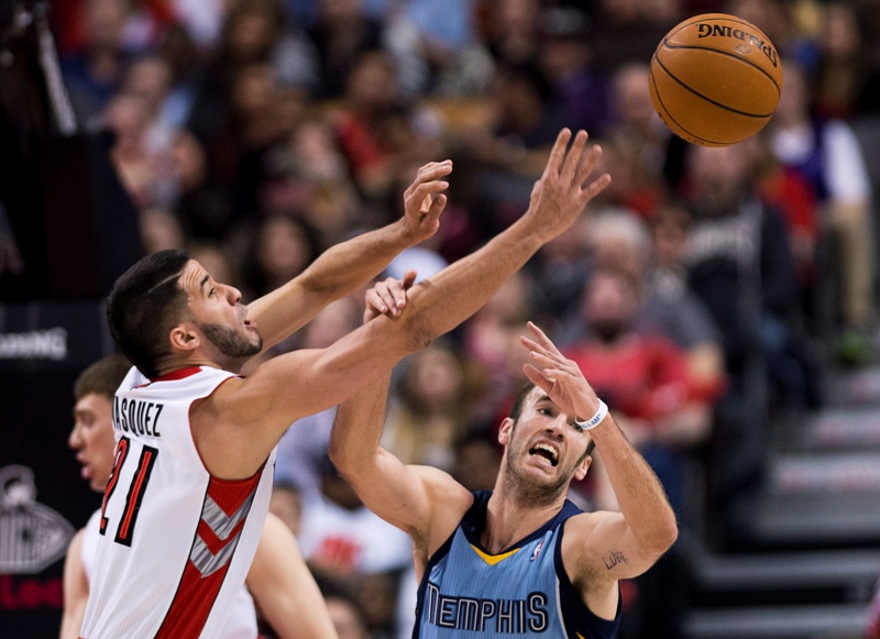 Toronto Raptors guard Greivis Vasquez, left, battlesd for the loose ball against Memphis Grizzlies guard Nick Calathes, right, during first half NBA basketball action in Toronto on Friday, March. 14, 2014. THE CANADIAN PRESS/Nathan Denette.
