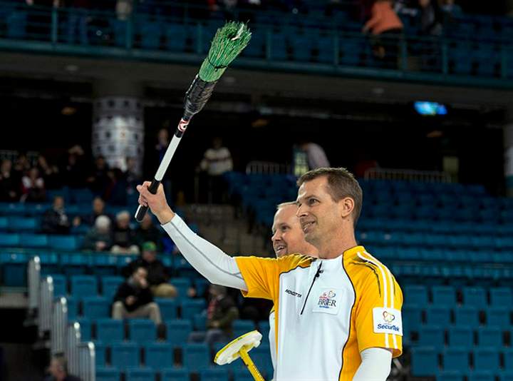 Manitoba skip Jeff Stoughton, right, and Mark Nichols head from the ice after defeating British Columbia 7-6 at the Tim Hortons Brier in Kamloops, B.C., on Thursday.