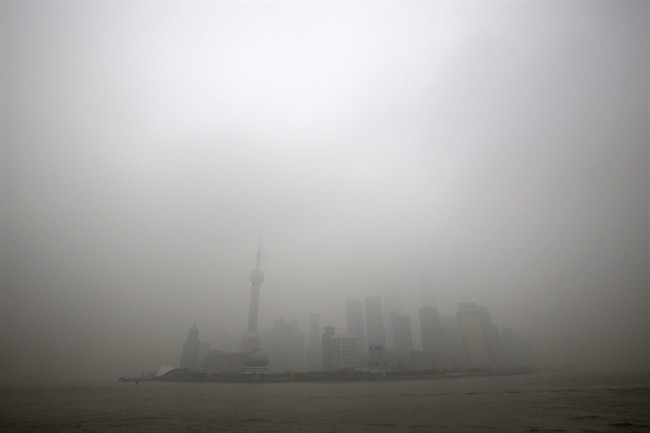 In this Monday, Dec. 9, 2013 file photo, the skyline of the Lujiazui Financial District with the high-rise buildings is covered with heavy smog in Pudong in Shanghai, China.