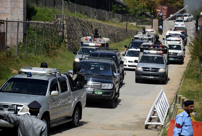The convoy of former Pakistani President Pervez Musharraf escorted by paramilitary troops, leaves the special court in Islamabad, Pakistan, Monday, March 31, 2014. 