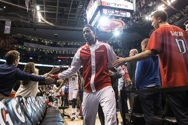 Toronto Raptors' DeMar DeRozan is congratulated by fans as he leaves the court following his team's 110-100 win over Milwaukee Bucks in NBA basketball action in Toronto on Monday, April 14, 2014.