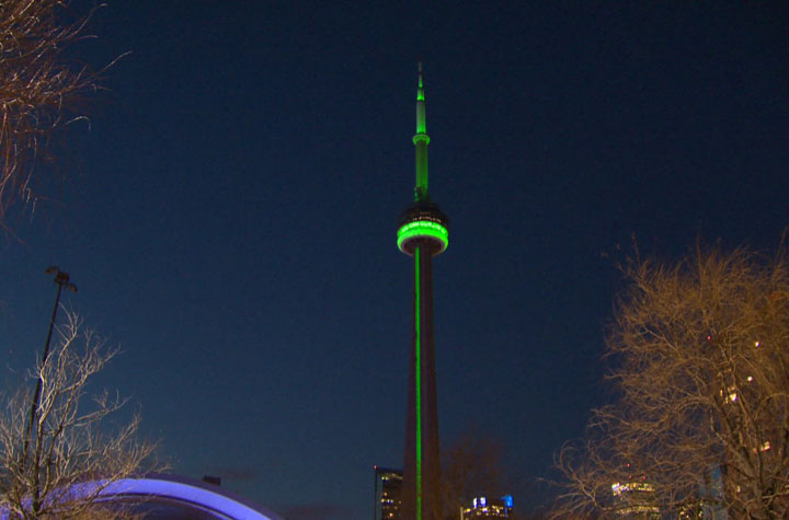 The CN Tower is bathed in green light Friday, April 11, as a tribute to Jim Flaherty.